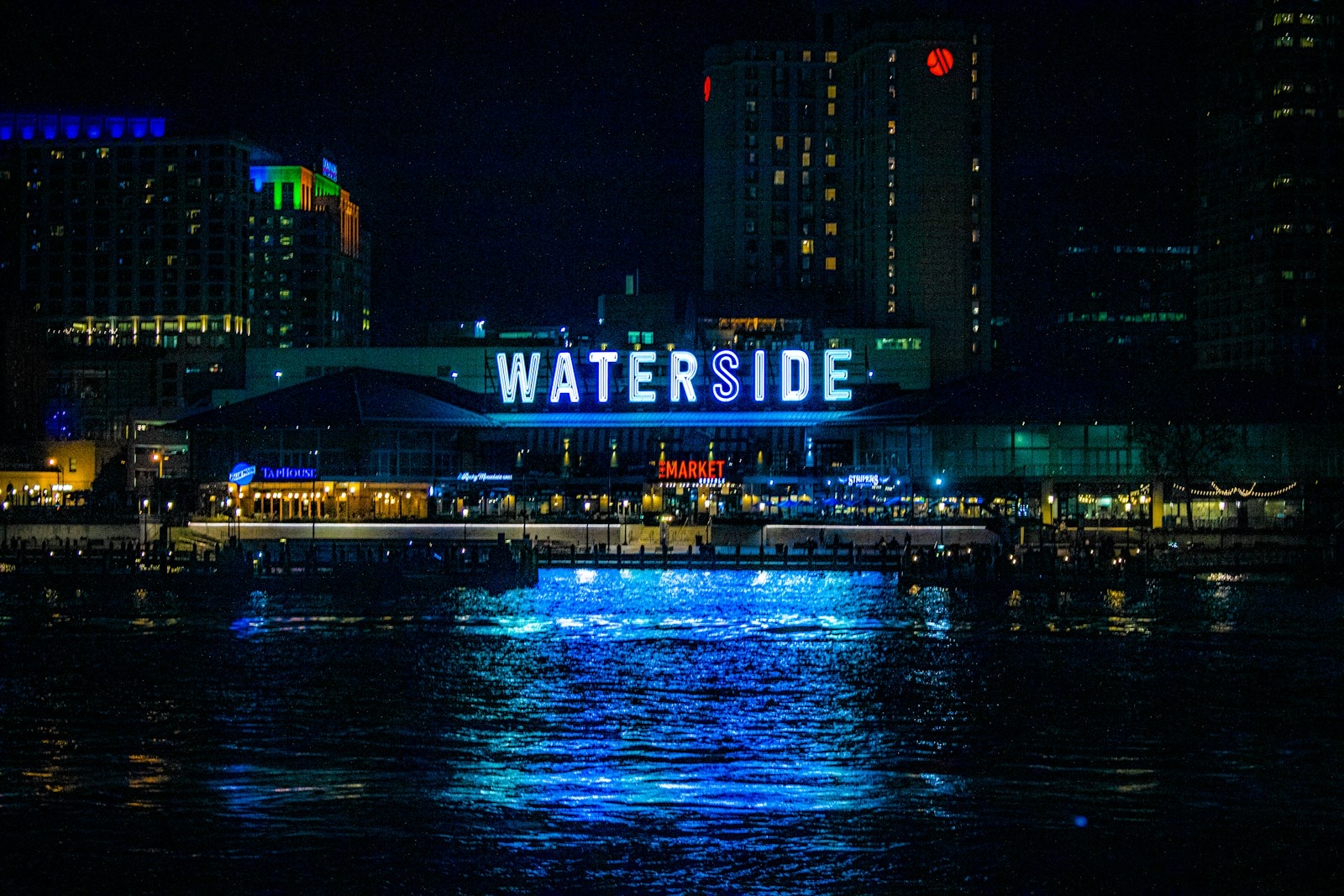 Norfolk's Waterside District lit up at night across the Elizabeth River